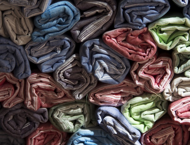 Rows of neatly arranged small-batch apparel samples showcasing diverse styles and fabrics.